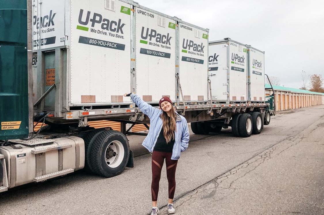 girl posing in front of upack moving relocubes