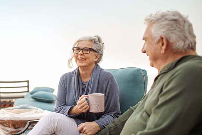 elderly couple taking a break from unpacking while moving
